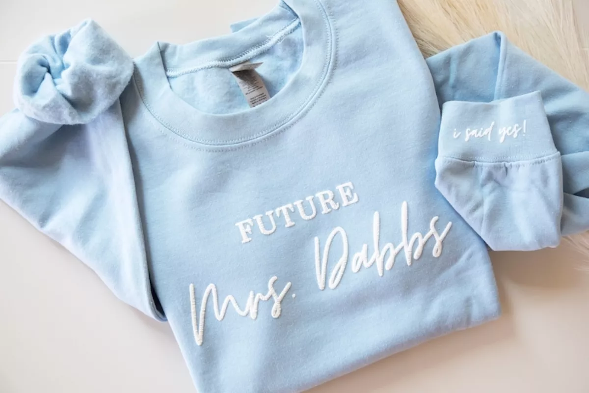 bride-to-be wearing personalized future mrs sweatshirt, cozy engagement gift from etsy