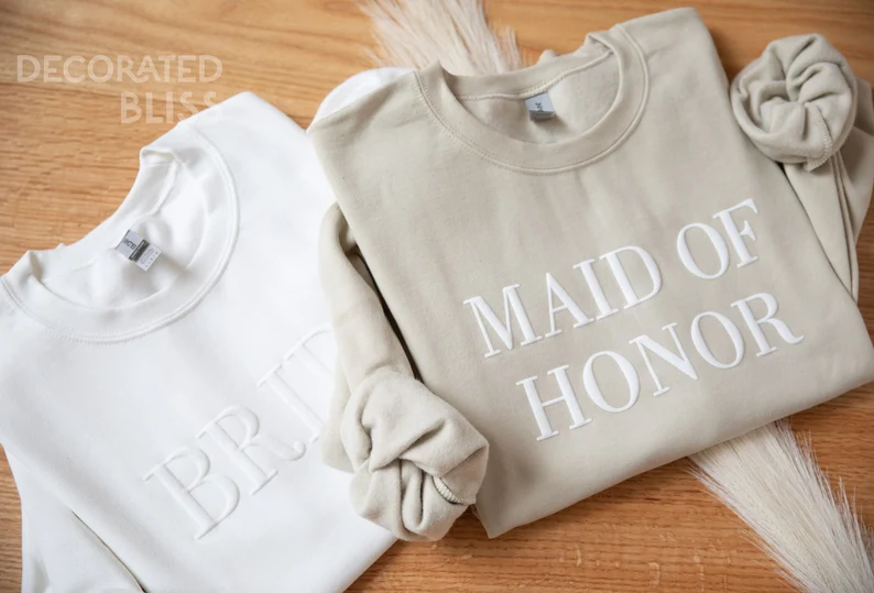 Bridal party wearing personalized bridal party sweatshirts for bachelorette and wedding day celebrations