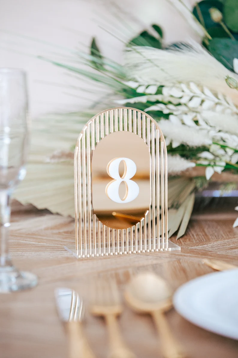 Vintage-inspired wedding table numbers in antique frames with rustic decor