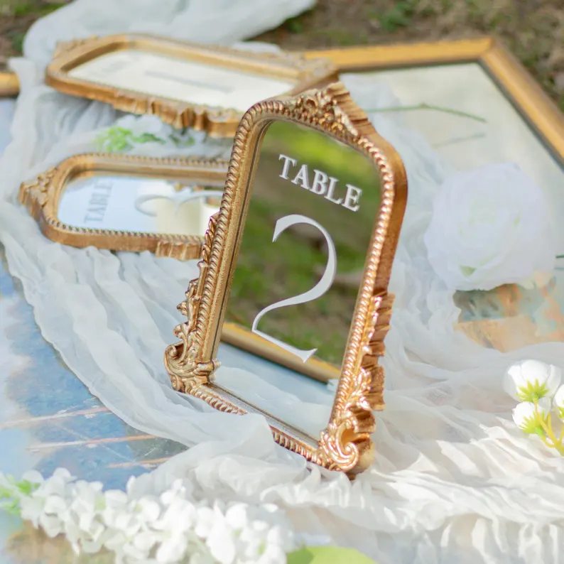 mirrored wedding table numbers in gold frames