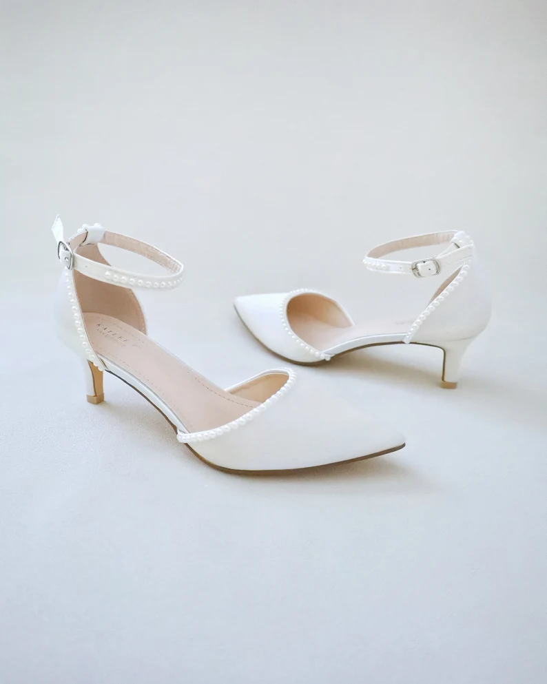 Pearl-embellished kitten heels adding sparkle to a bridal look
