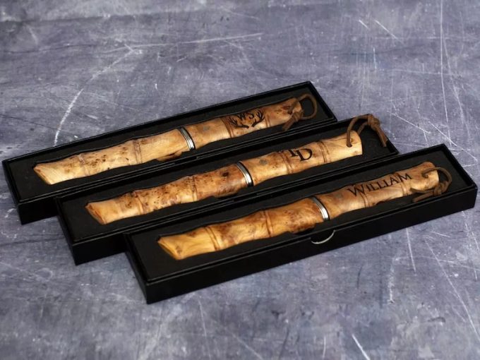 Personalized Damascus steel bushcraft knife with engraved wooden handle, ideal non-tacky groomsmen gift