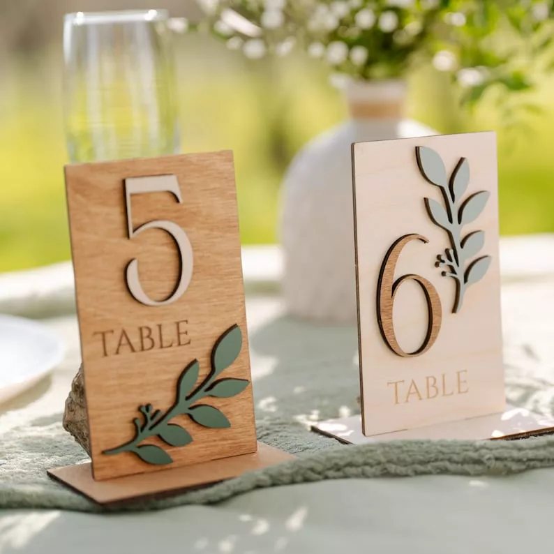 Custom engraved wooden wedding table numbers from Etsy with rustic floral centerpiece