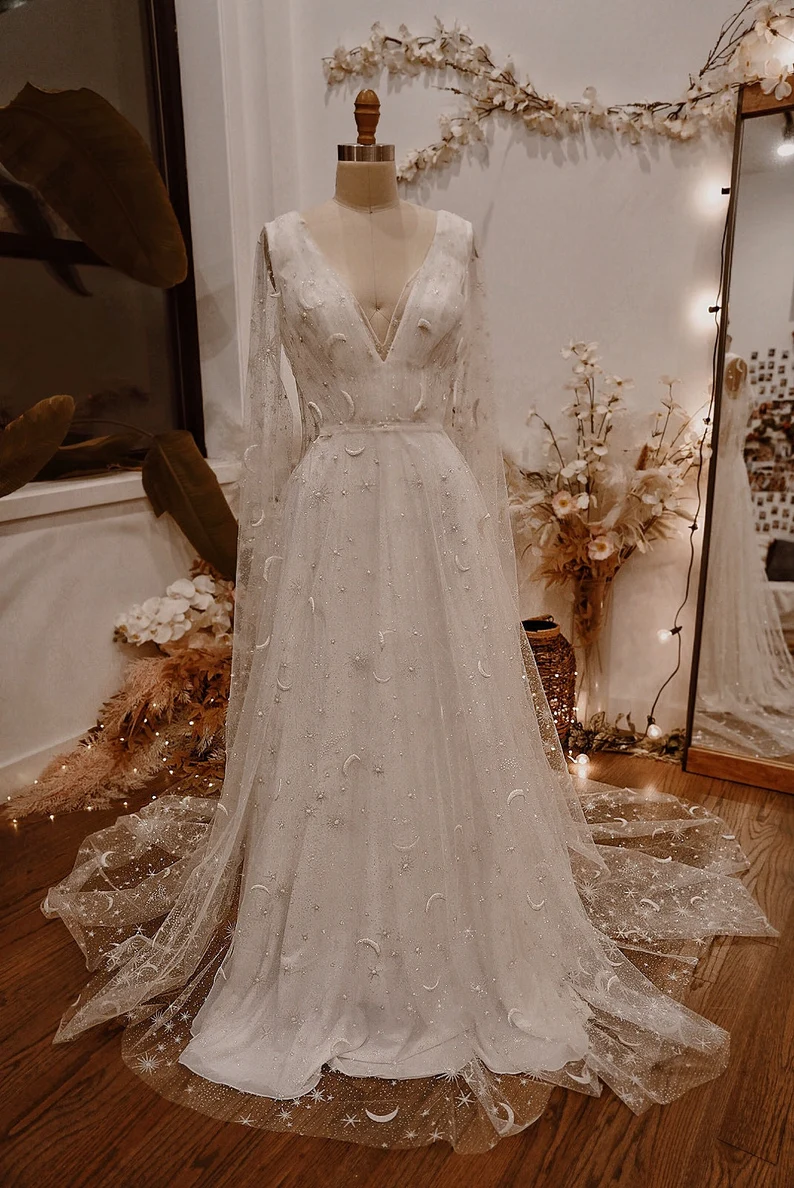 Bride trying on a custom Etsy wedding dress with designer assistance
