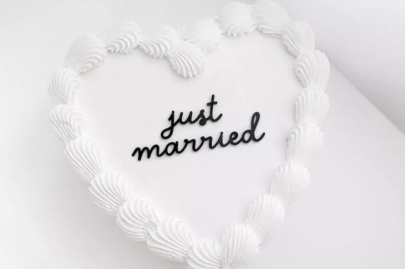 Acrylic wedding cake topper with just married text
