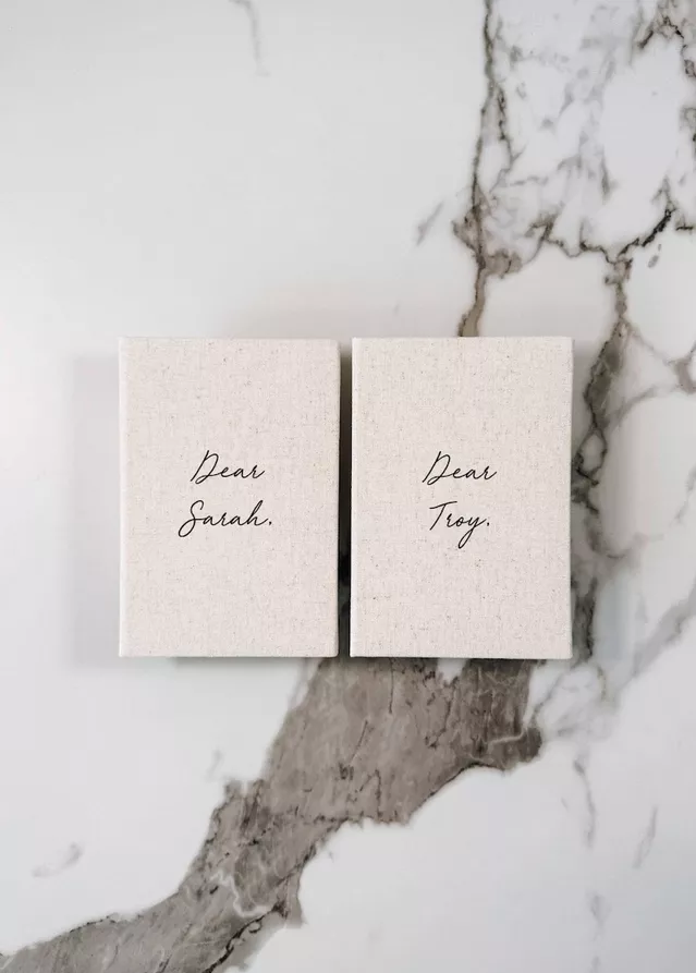 modern linen vow books with neutral cover and dear with name for personalization instead of his or hers