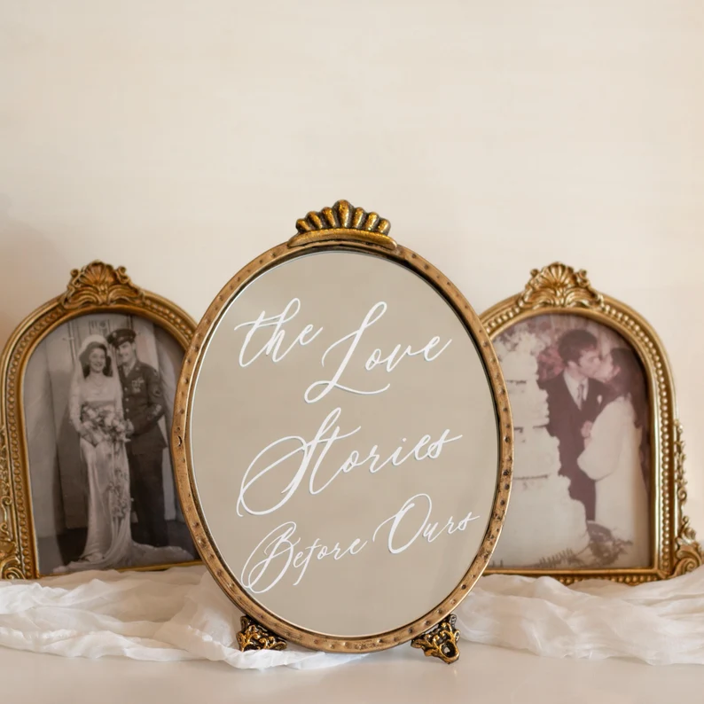 Sign for love stories before yours to display at your wedding with frames grandparents' wedding pictures