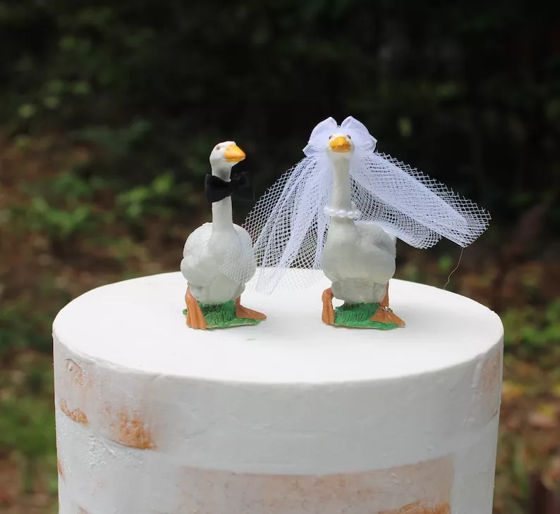 Playful geese wedding cake topper adding personality without increasing wedding costs