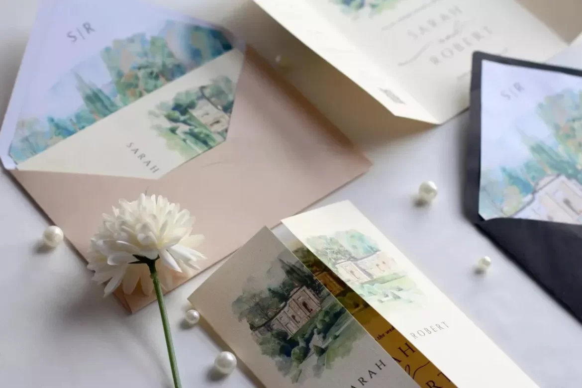 Elegant trifold wedding invitation with watercolor design folded neatly on a wedding table