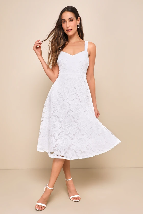 Bride wearing a white lace midi length dress to the bridal shower