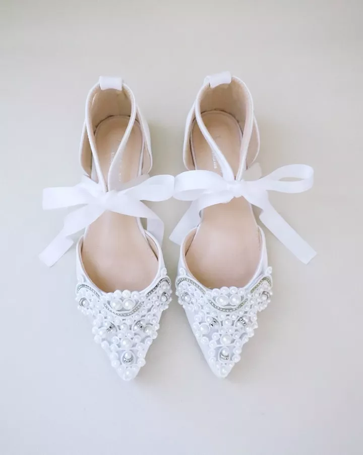 Bride shoes for the bridal shower in a flat style with cute ribbon and pearl embellishment