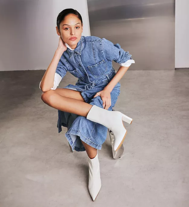 Bride wearing white Mino ankle boots by Bared