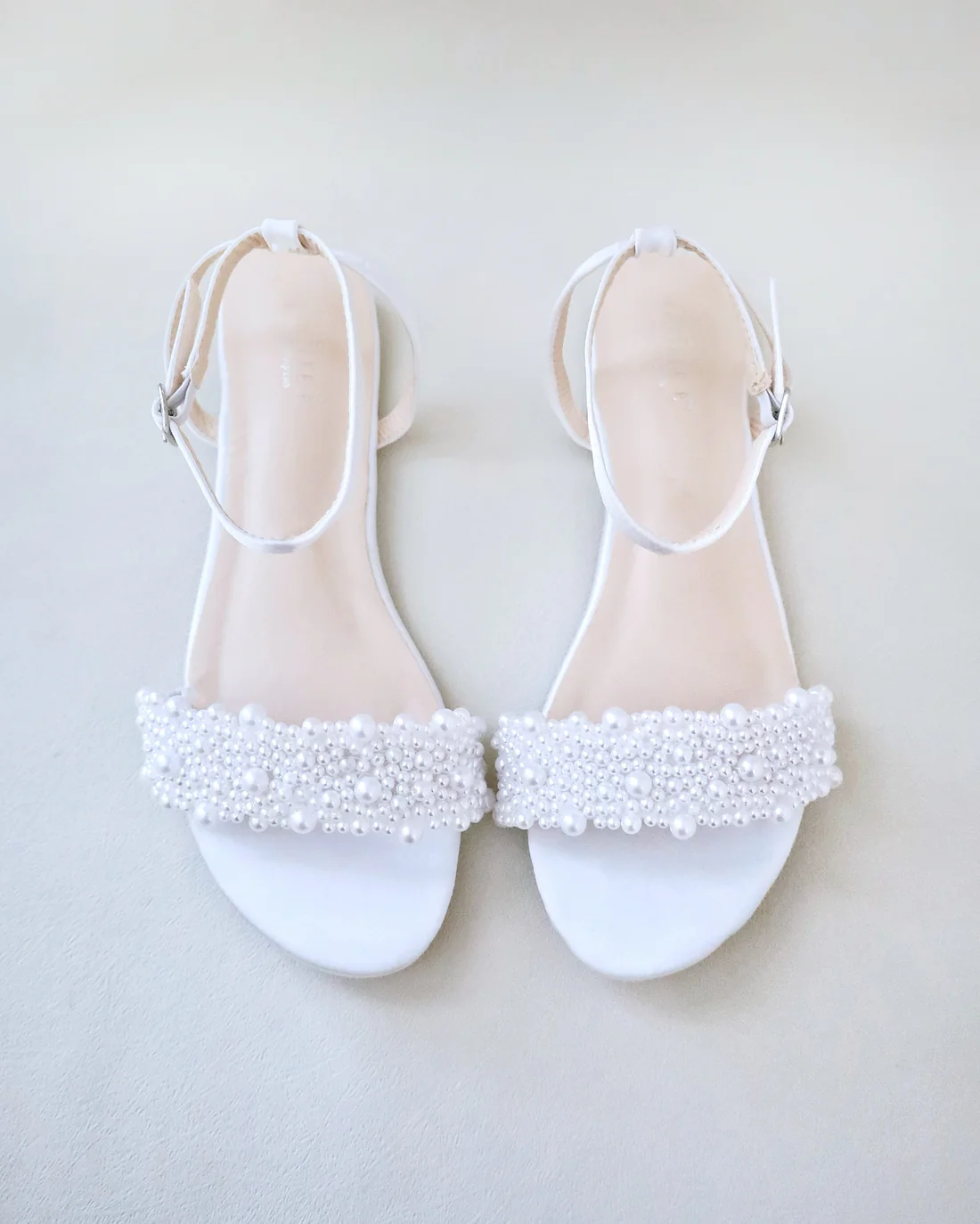 bridal shoes for beach wedding: flats, wedges, and barefoot sandals on sand