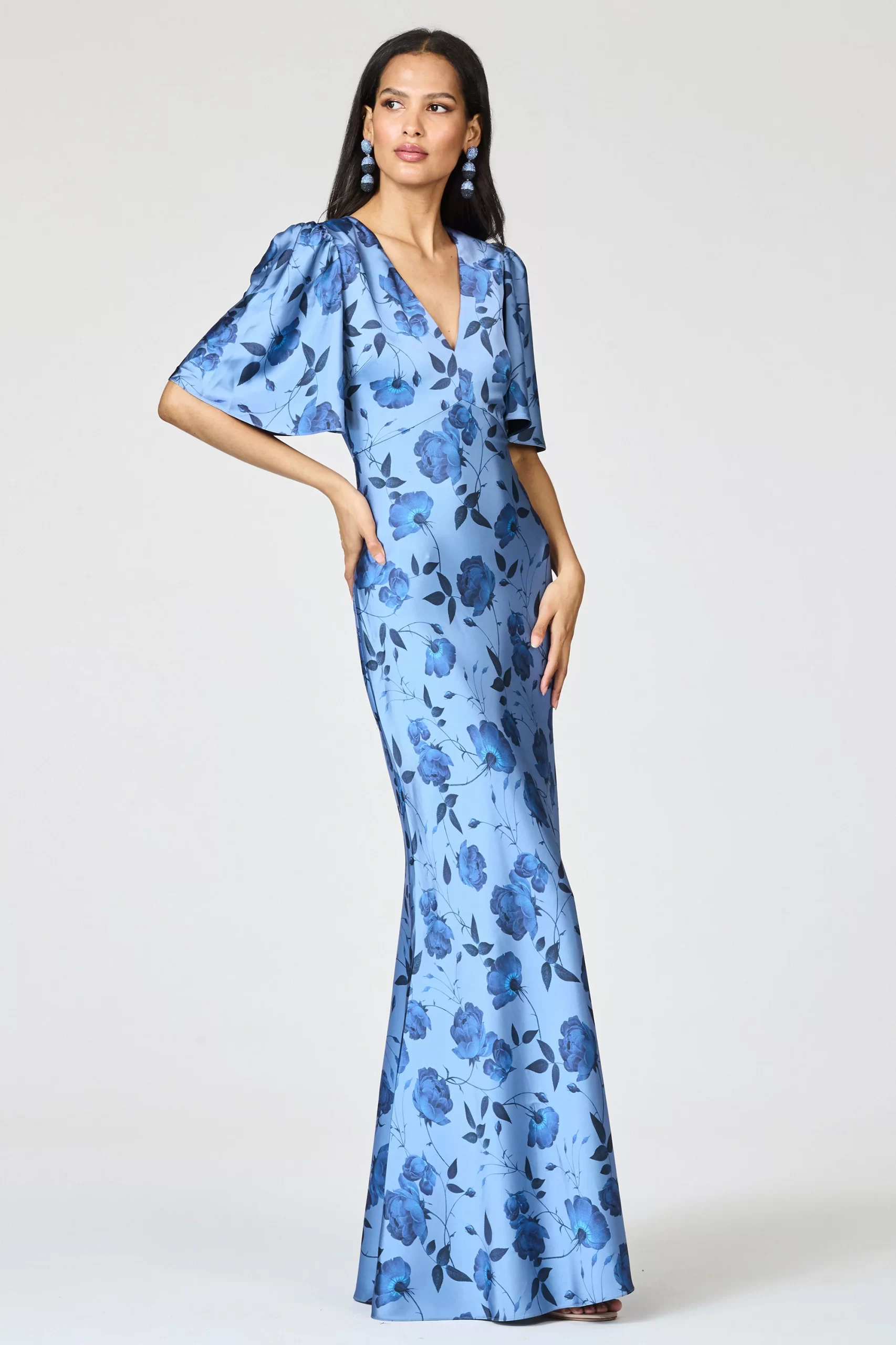 guest wearing flutter sleeve beach wedding guest dress, maxi length skirt