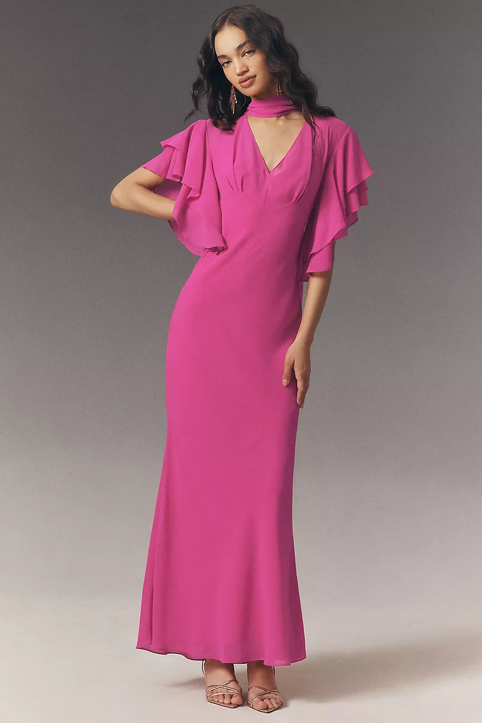 guest wearing magenta wedding guest dress for beach wedding with flutter sleeves, elegant scarf style