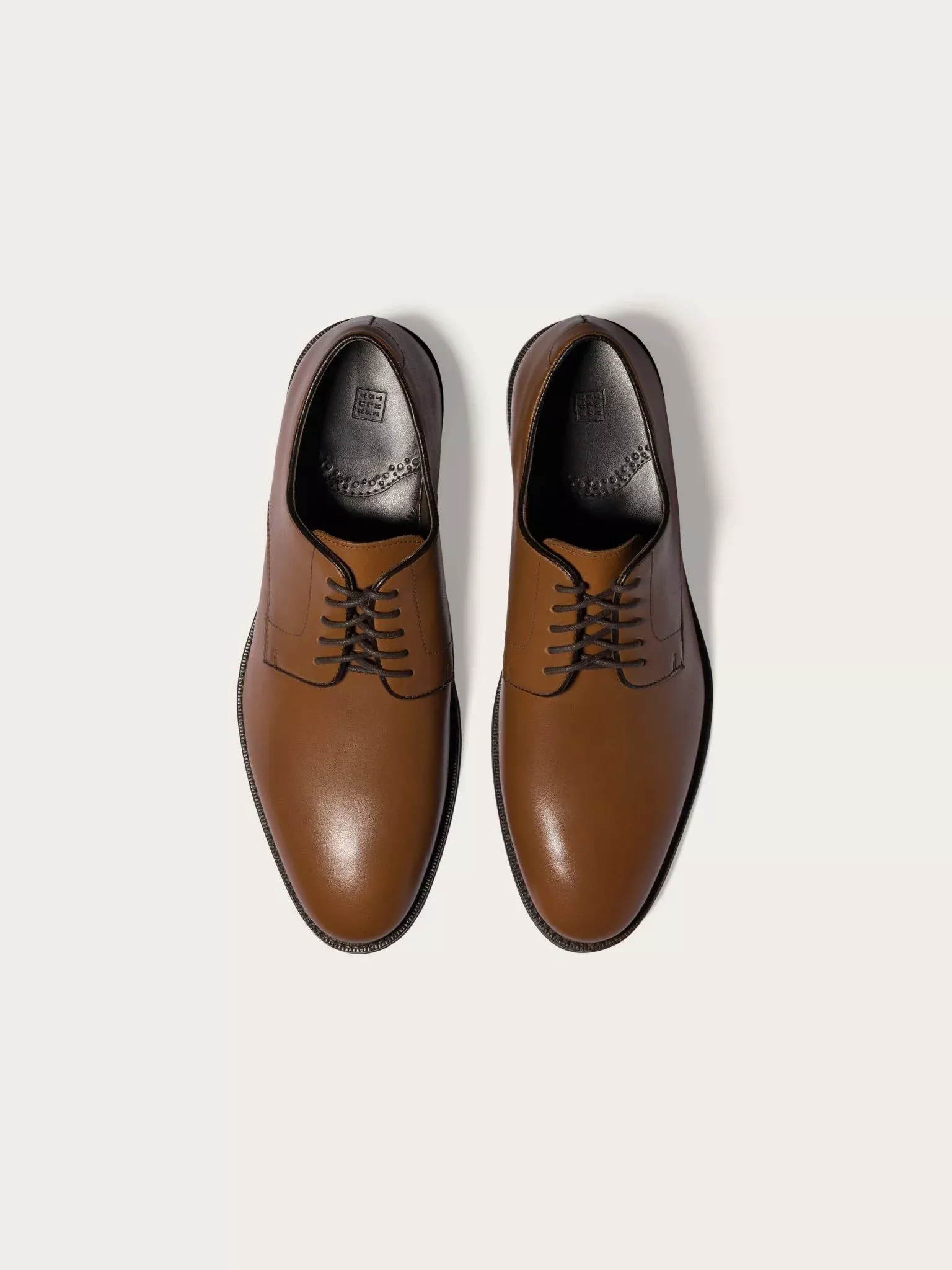 Pair of brown leather lace up shoes for beach wedding mens footwear
