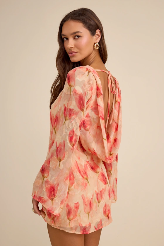 guest wearing peach floral print mini dress with long sleeves for beach wedding