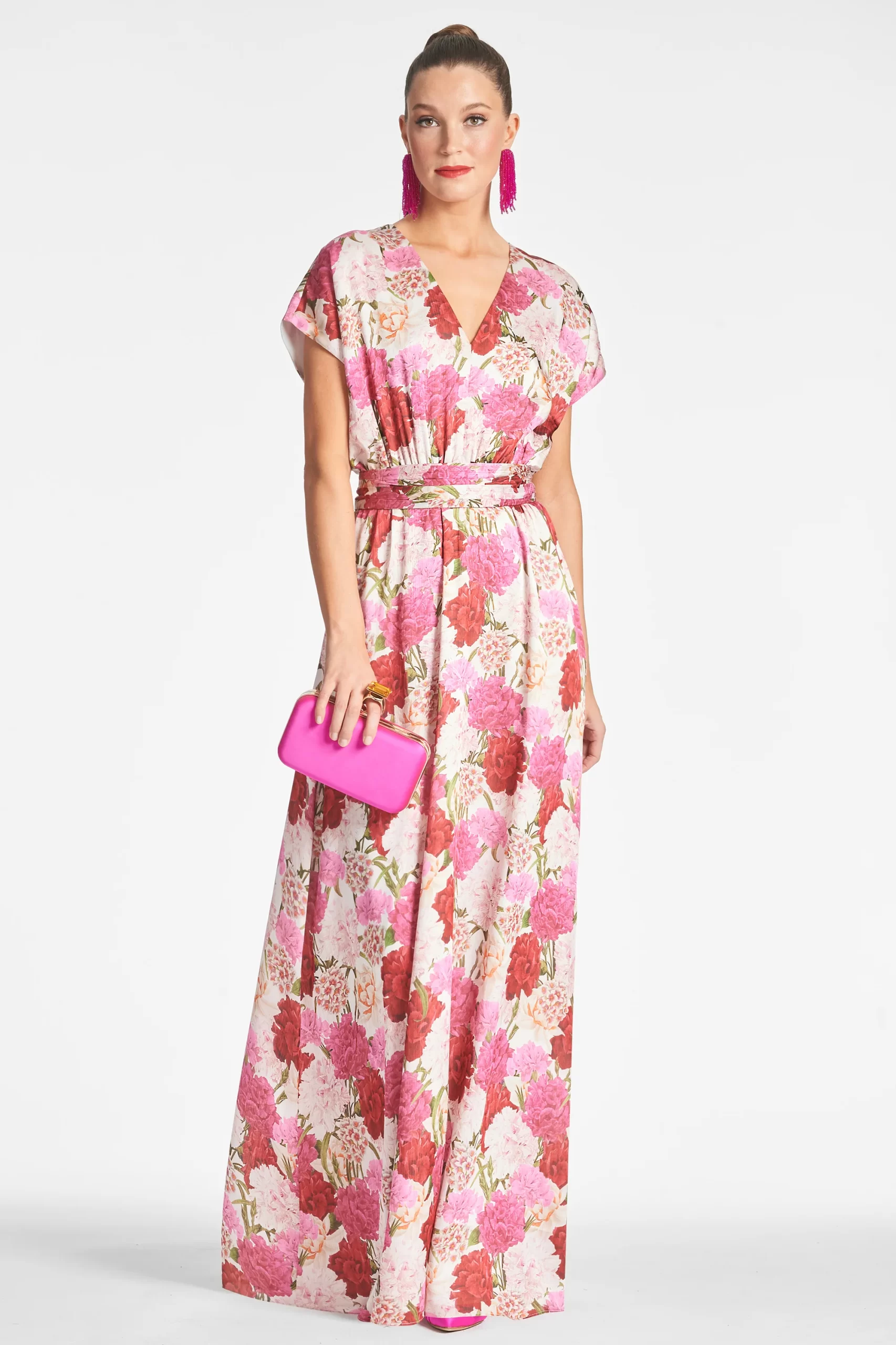 guest wearing bright pink floral print maxi for beach wedding guest dress with sleeves, cap style sleeve