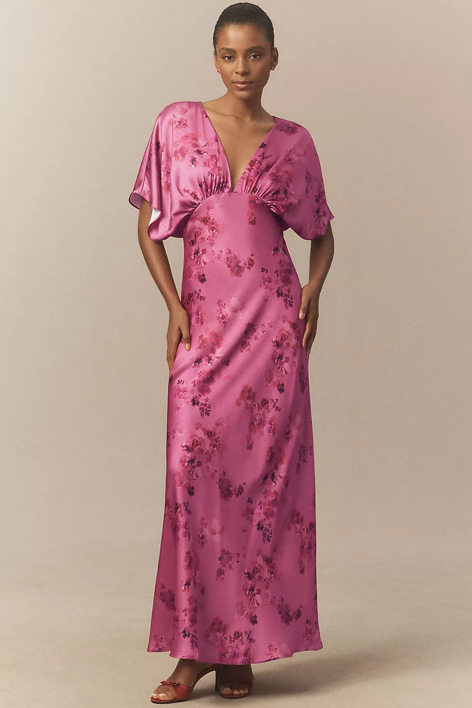 guest wearing pink satin flutter sleeve beach wedding guest dress
