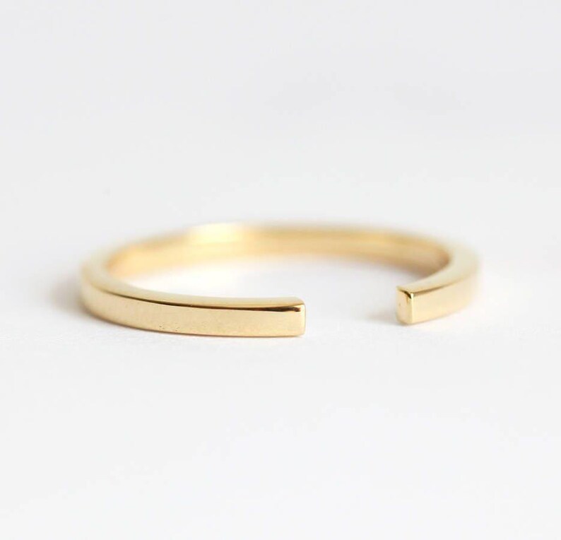 simple open wedding band in gold to fit engagement ring stone