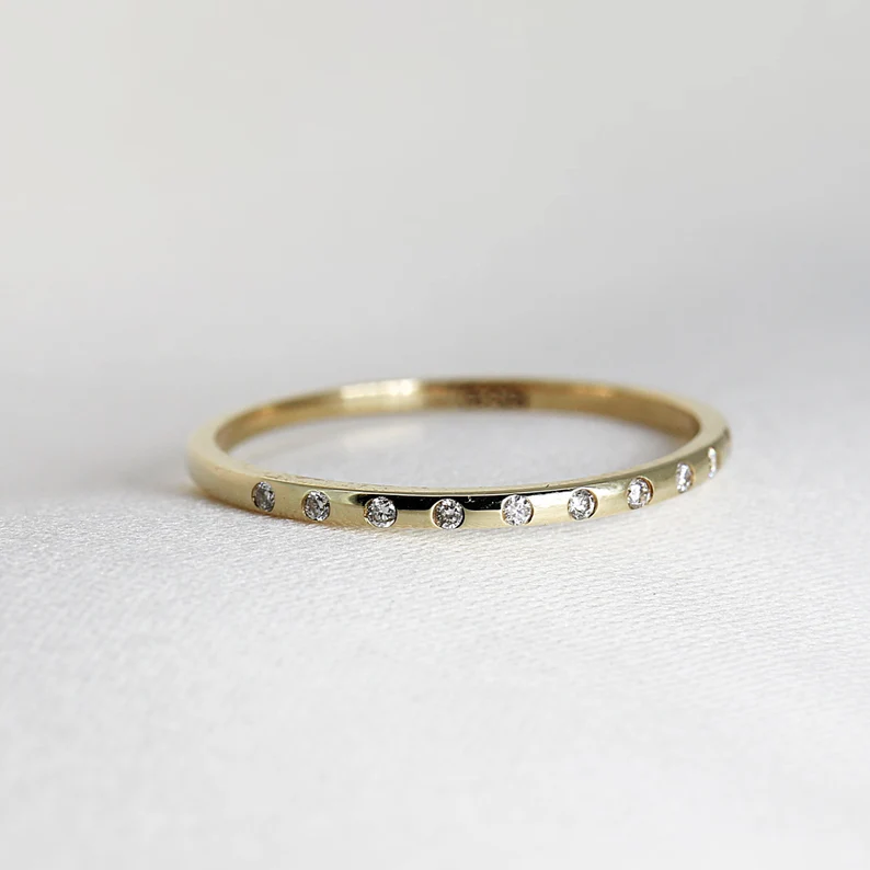 thin stackable wedding bands layered with engagement ring dainty gold stack