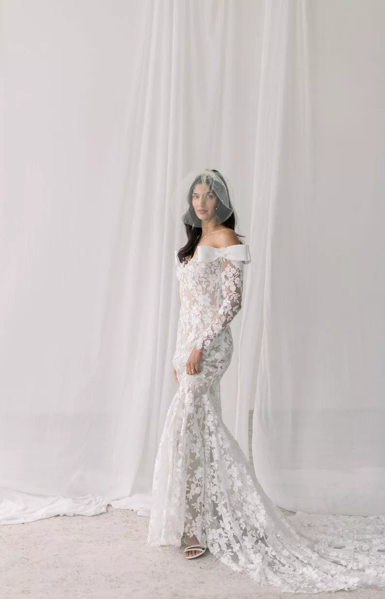 bride wearing elegant lace bridal gown with simple wedding veil birdcage tulle style