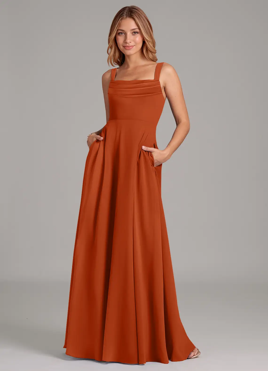 bridesmaid wearing burnt orange azazie bridesmaid dress with pockets