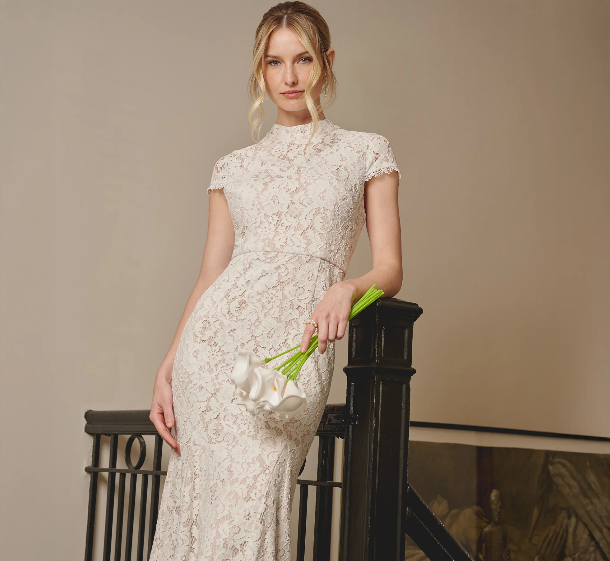 bride wearing elegant cap sleeve floral lace bridal shower dress in midi length