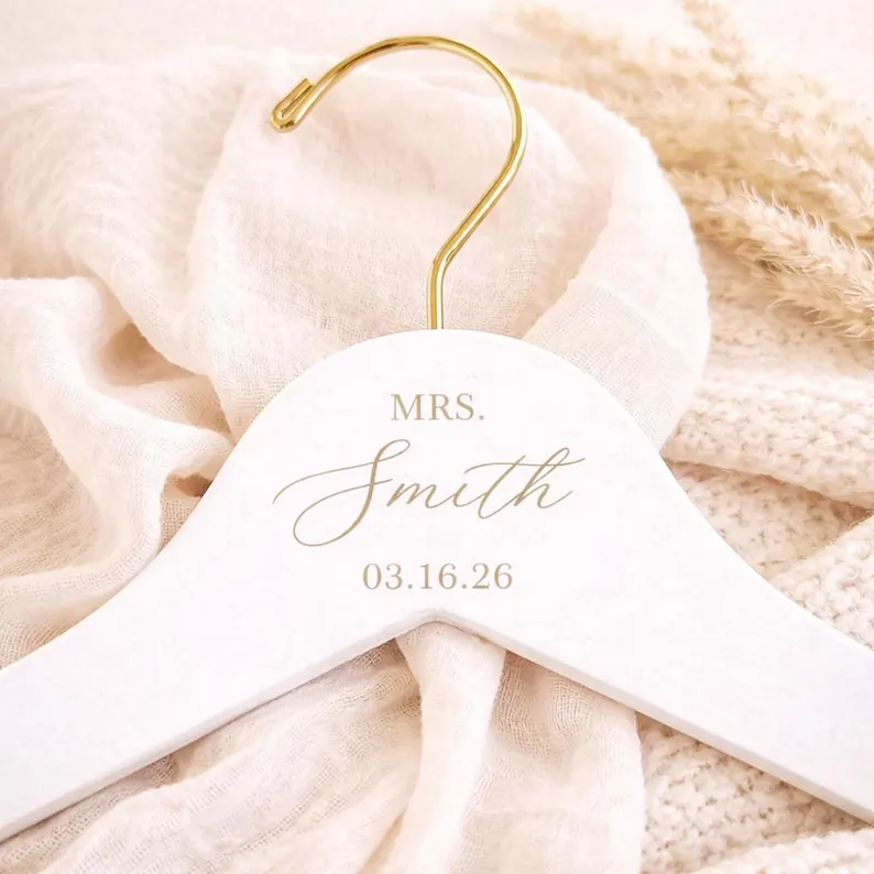 white wooden wedding dress hanger personalized with mrs and wedding date