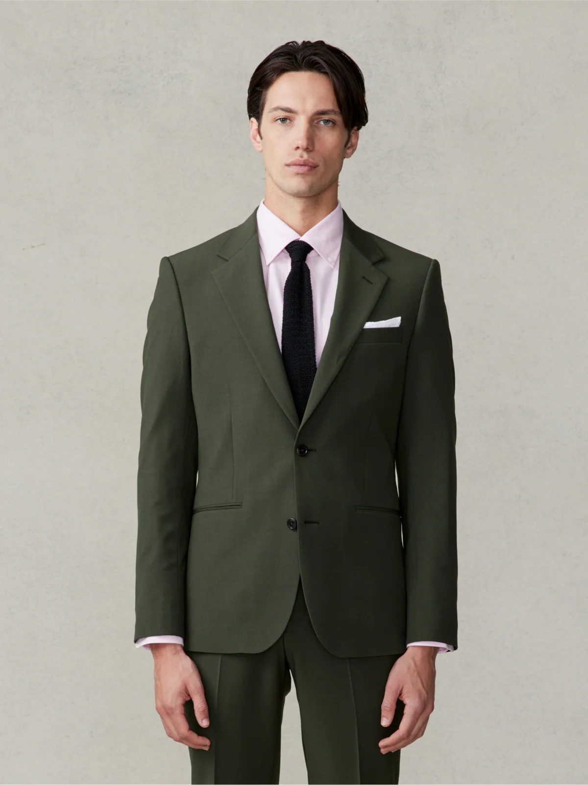 groom wearing dark green suit for wedding day