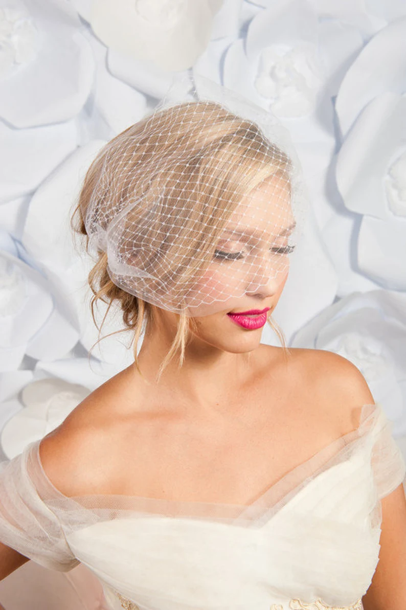 bride wearing simple bridal veil with bandeau style birdcage tulle