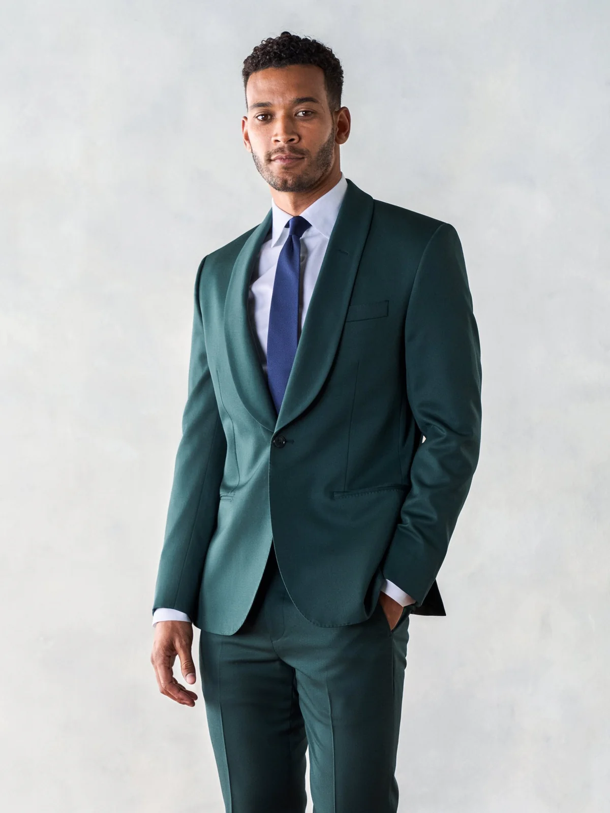 groom wearing dark green emerald wedding suit