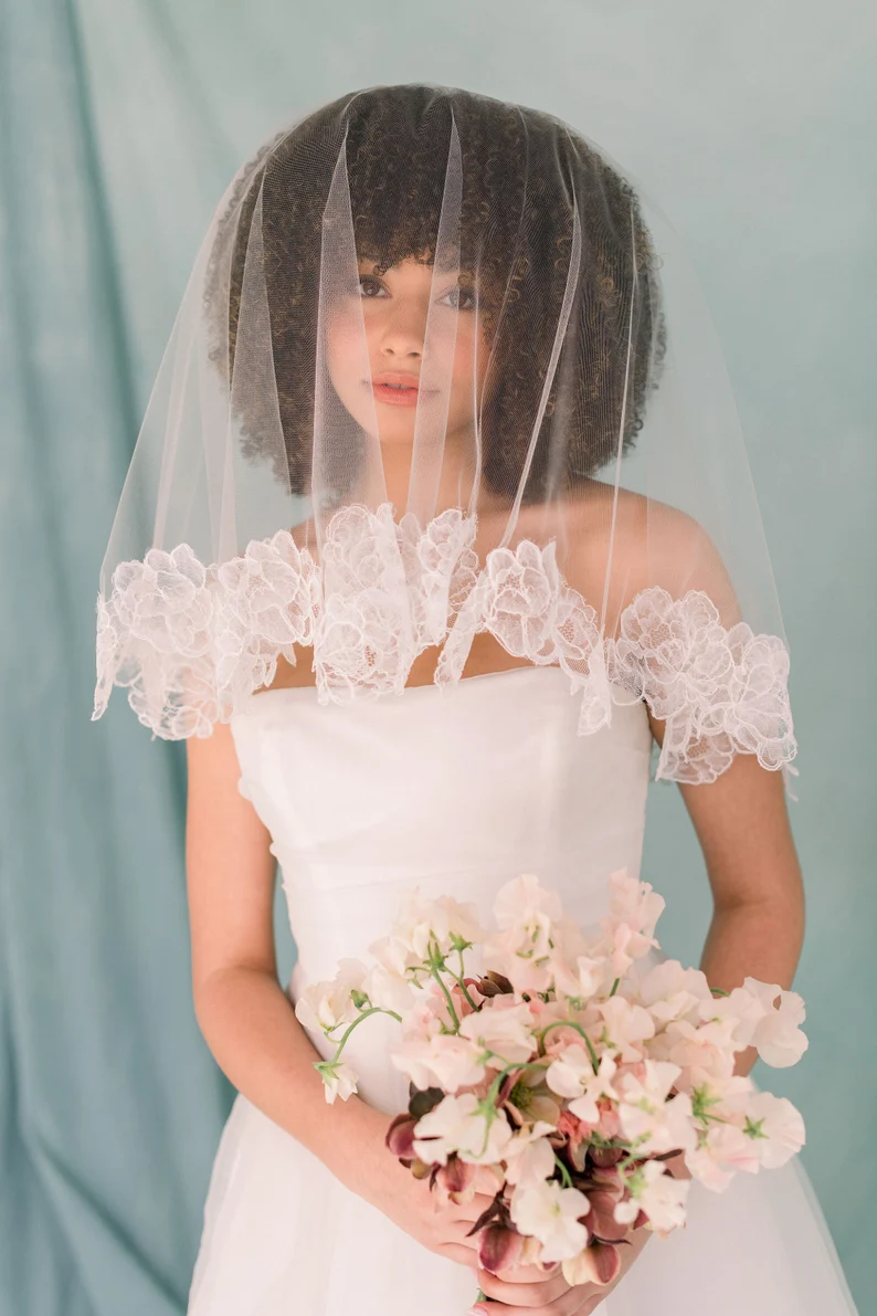 bride wearing modern floral lace trim veil