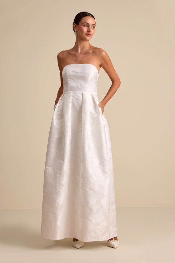 bride wearing strapless floral maxi bridal shower dress with pockets