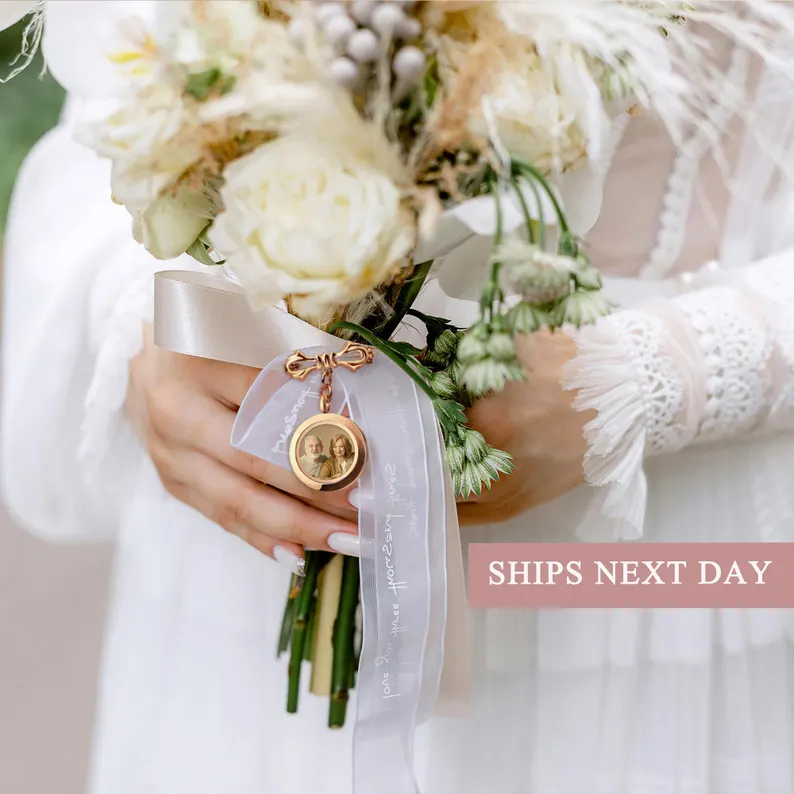 wedding flower bouquet with round photo charm attached