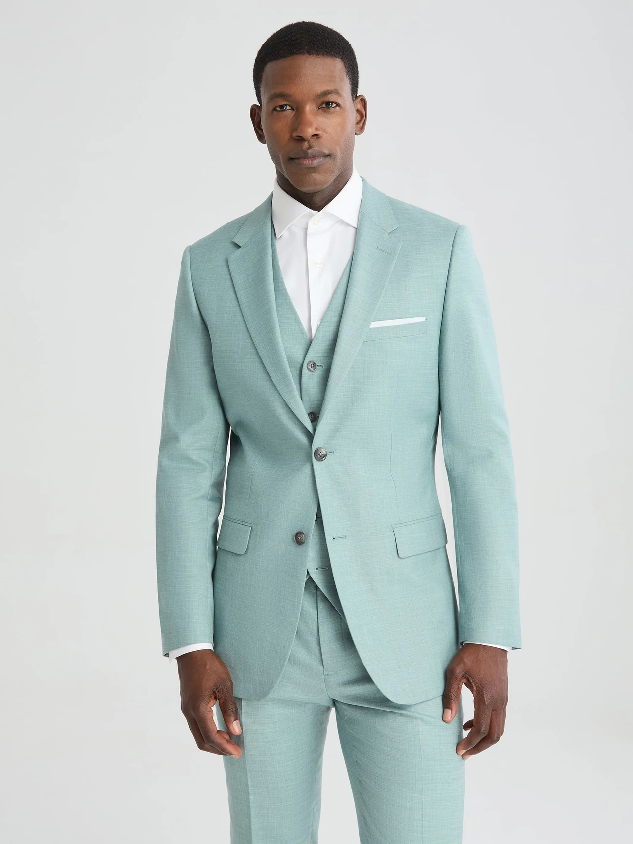 groom wearing sea foam green suit for wedding attire