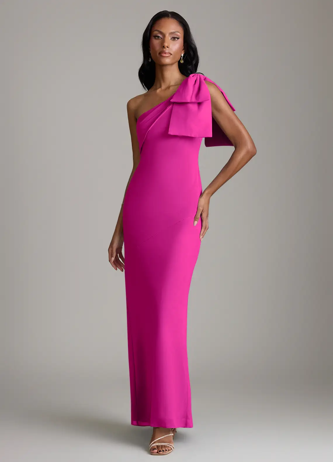 bridesmaid wearing fuchsia one-shoulder bow adorned azazie bridesmaid dress