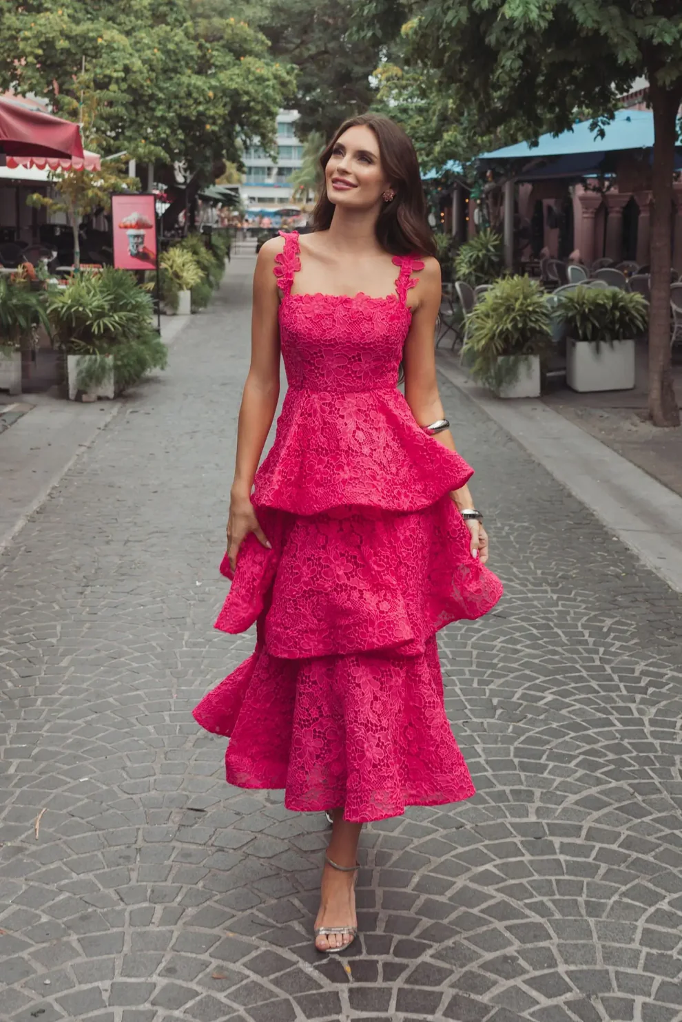 wedding guest wearing hot pink ruffle tiered guest dress for garden formal style