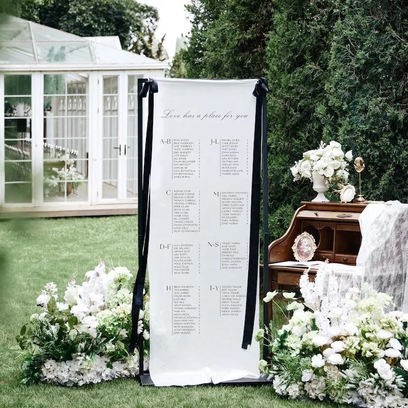 sheer hanging wedding seating chart on fabric