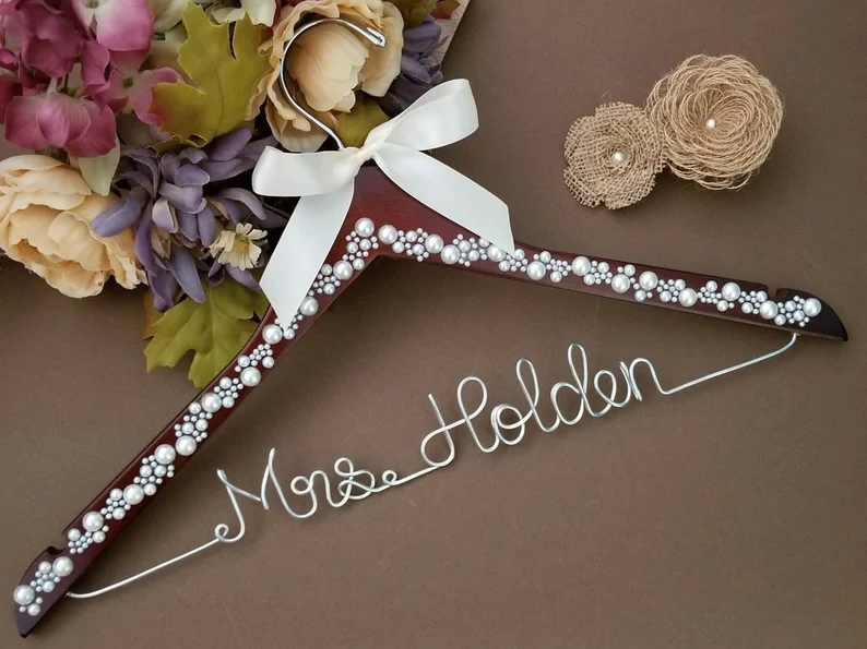 wedding dress hanger with pearls and dark wood and personalized wire name on bottom