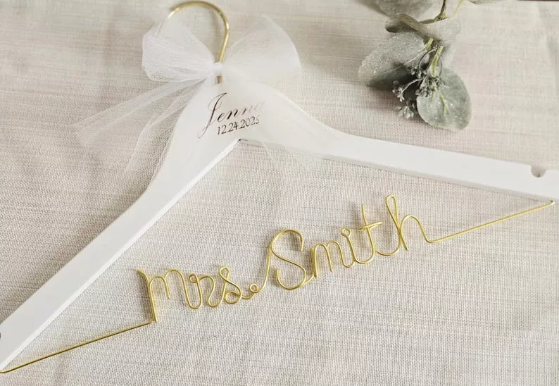 wedding dress hanger for the bride with white wood and gold wire lettering