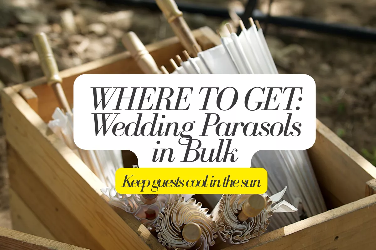 white wedding parasols in bulk displayed in basket at outdoor wedding ceremony entrance for guest shade