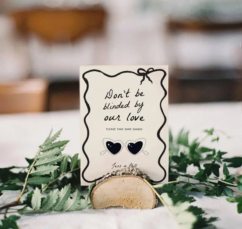 sunglasses favors sign on display at wedding reception