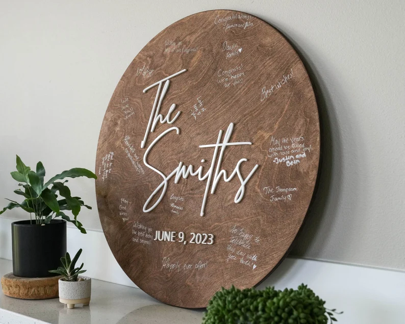 welcome sign made of wood that can be reused as guest book with signatures