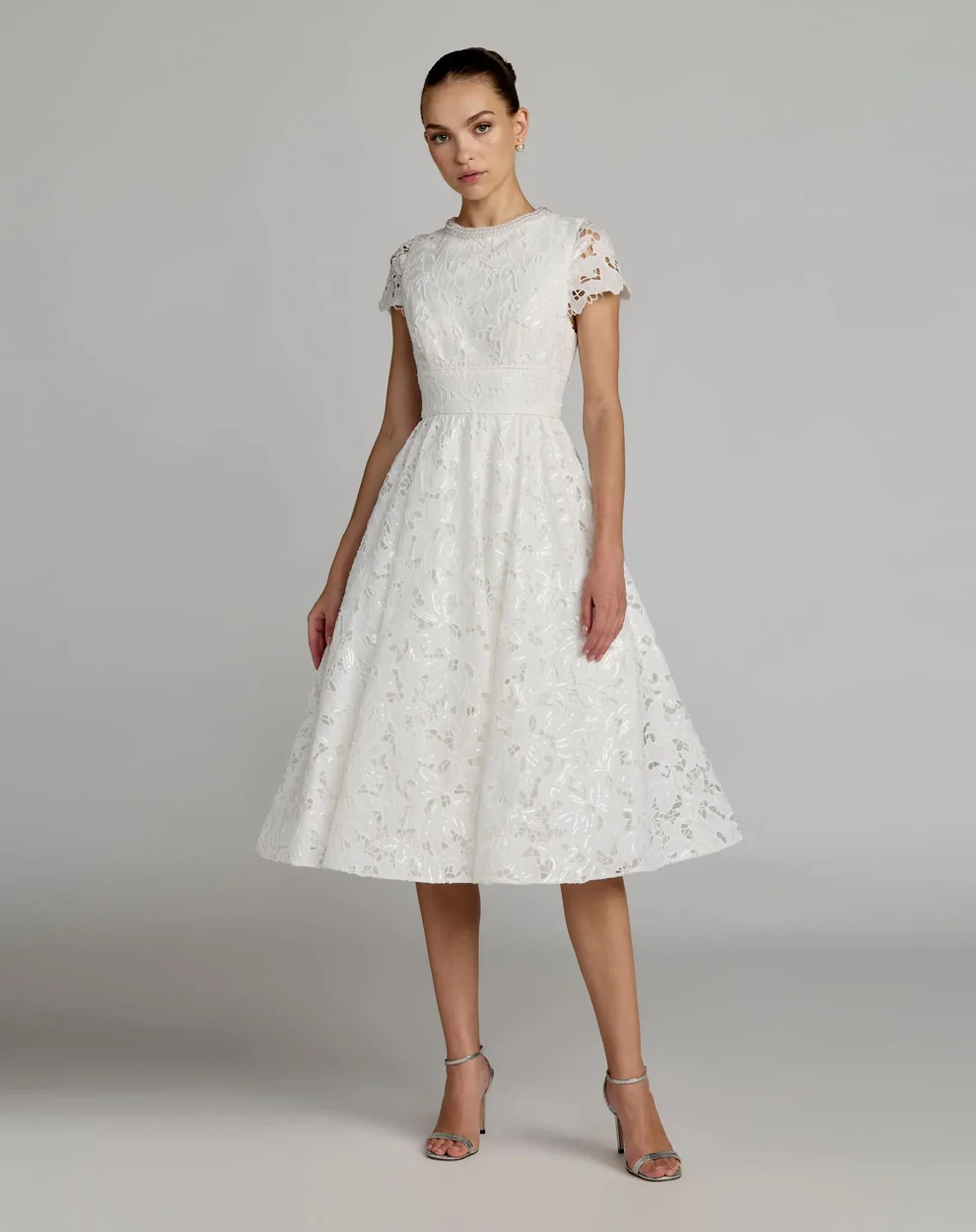 bride wearing flared a-line cap sleeve floral bridal shower dress