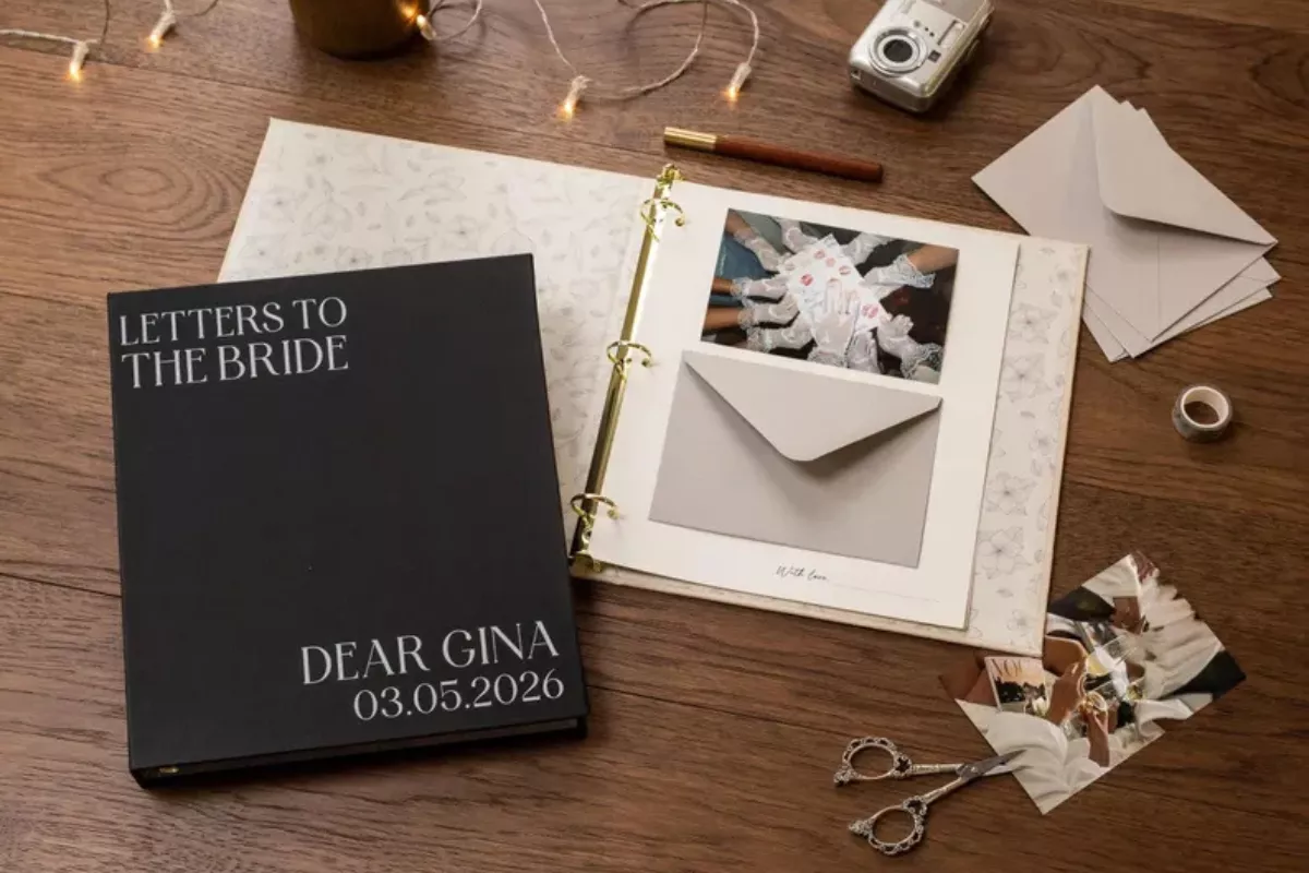 bride holding a wedding day letter book filled with handwritten notes from loved ones