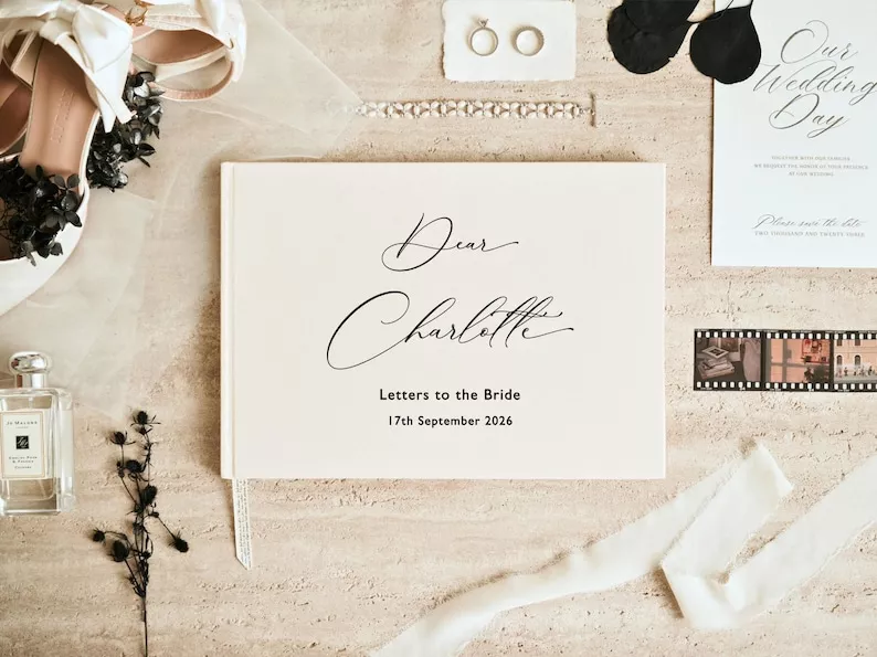 flat lay of a wedding day letter book with flowers, ribbon, and handwritten notes