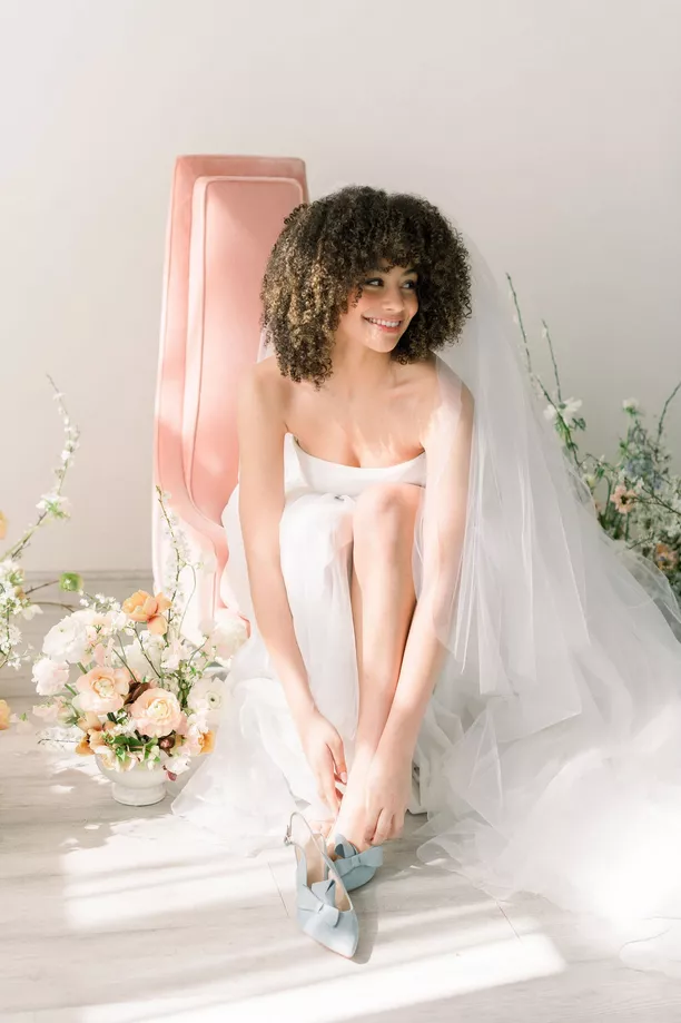 bride with veil that covers face but lifted at the moment