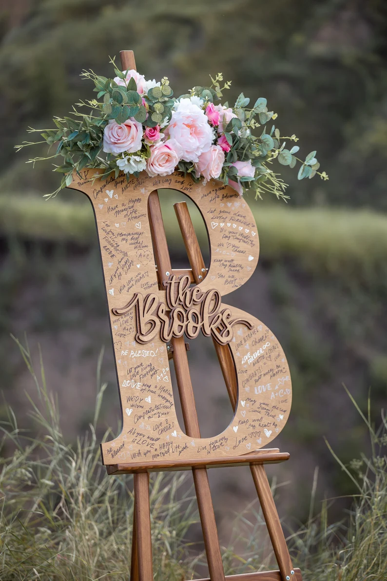 large wooden letter for guests to sign at wedding