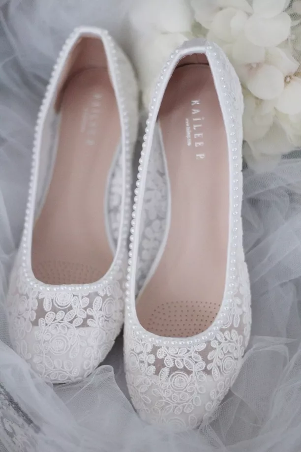 white wedding flats with pearl details for brides